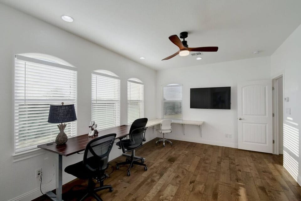 The office is situated between the mother-in-law suite and the main part of the house. It has plenty of table-top space for the digital nomad or remote worker to spread out, with a variety of rolling chairs to choose from