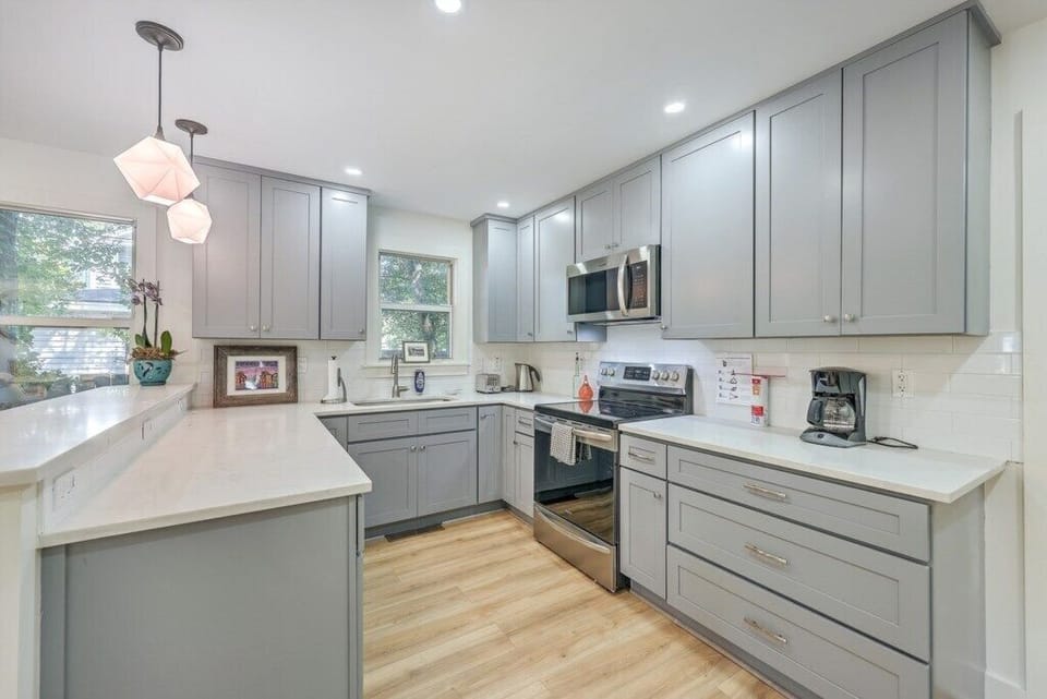 Fully equipped kitchen with ample counter space and modern stainless steel appliances.