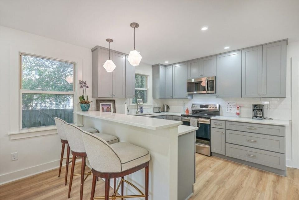 Sleek kitchen bar with comfortable stools, perfect for casual dining or morning coffee.