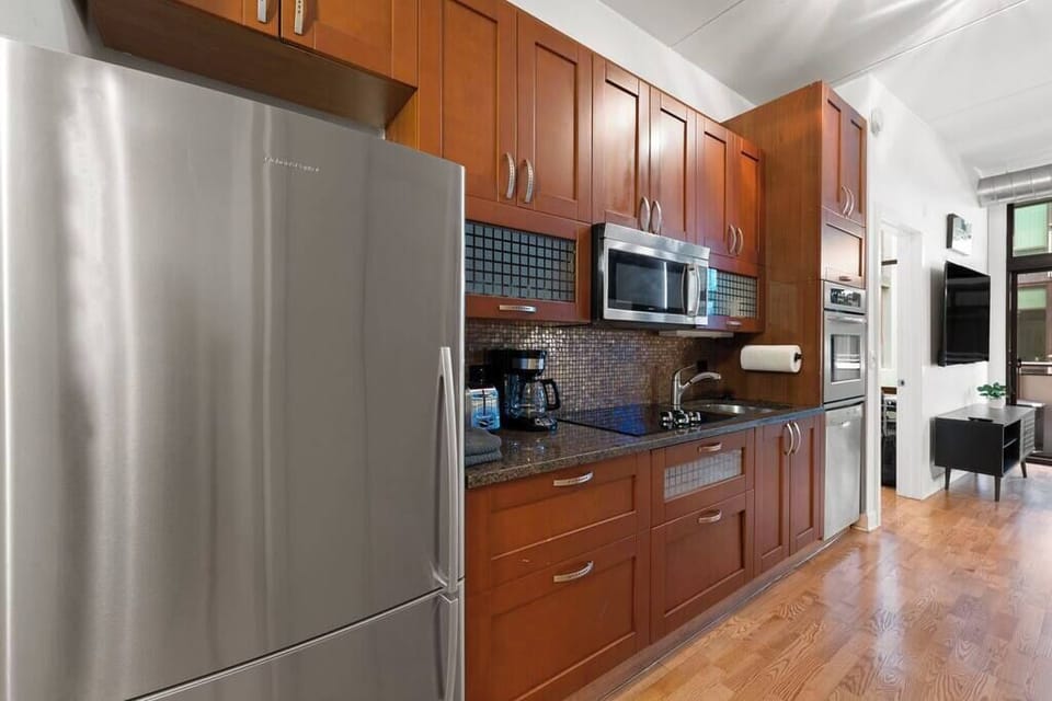 Modern kitchen w/ stainless appliances and sleek cabinetry for simple, everyday cooking.