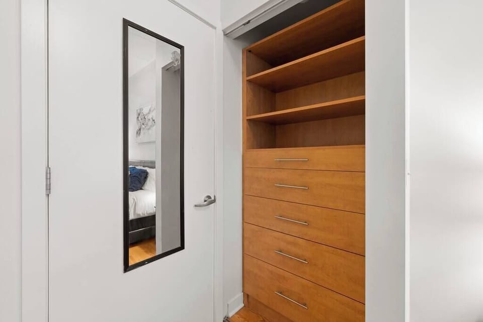 Hallway storage w/ open shelving and hanging space to keep essentials organized.