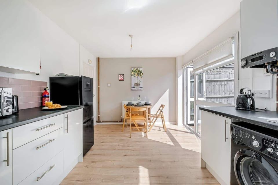 A sleek, modern kitchen fully equipped with everything you need, plus a cosy dining table with 3 chairs for enjoying your meals or casual conversations