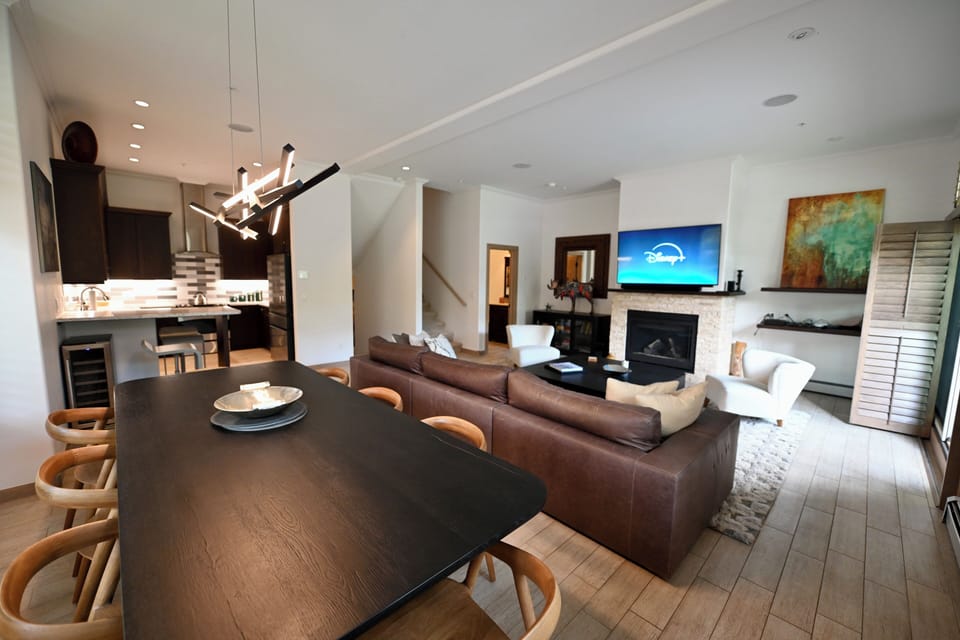 Dining, kitchen, living room, powder room at the rear of the photo
