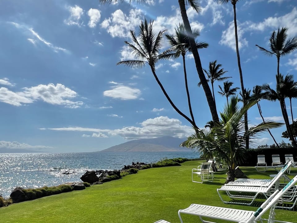 Shared community space with tables and lawn chairs with views of nearby islands