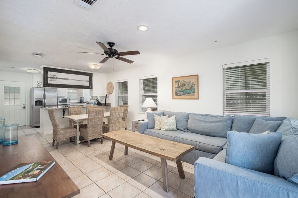 Relax in your spacious open-plan living area with comfortable blue sectional seating, perfect for unwinding after exploring.