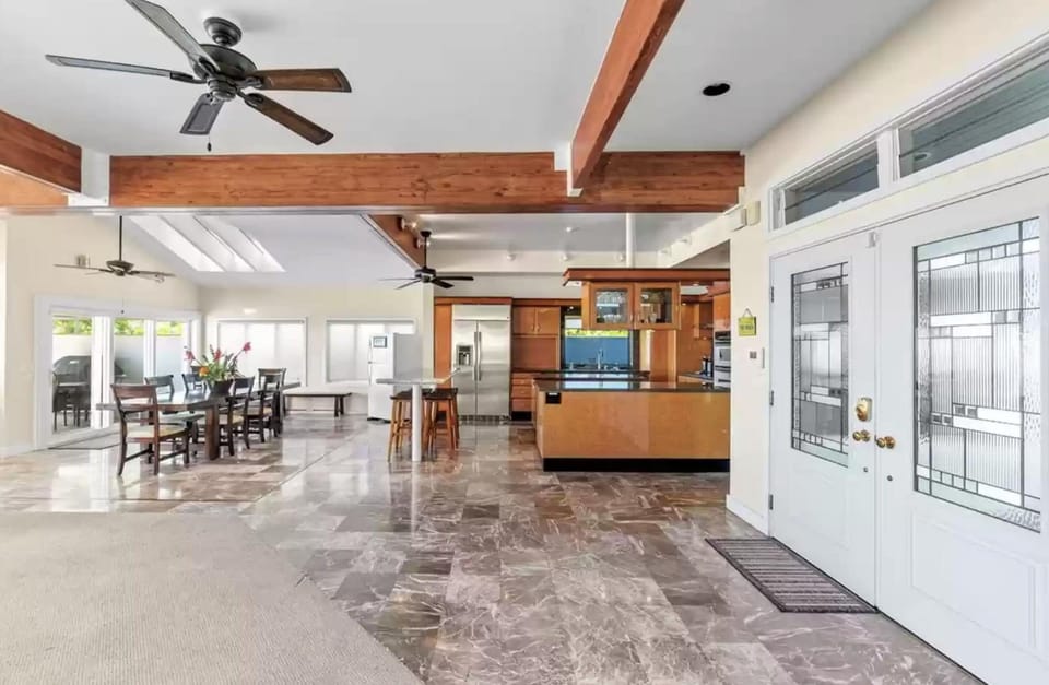 Frontdoor foyer area looking into open first floor plan kitchen and dining areas