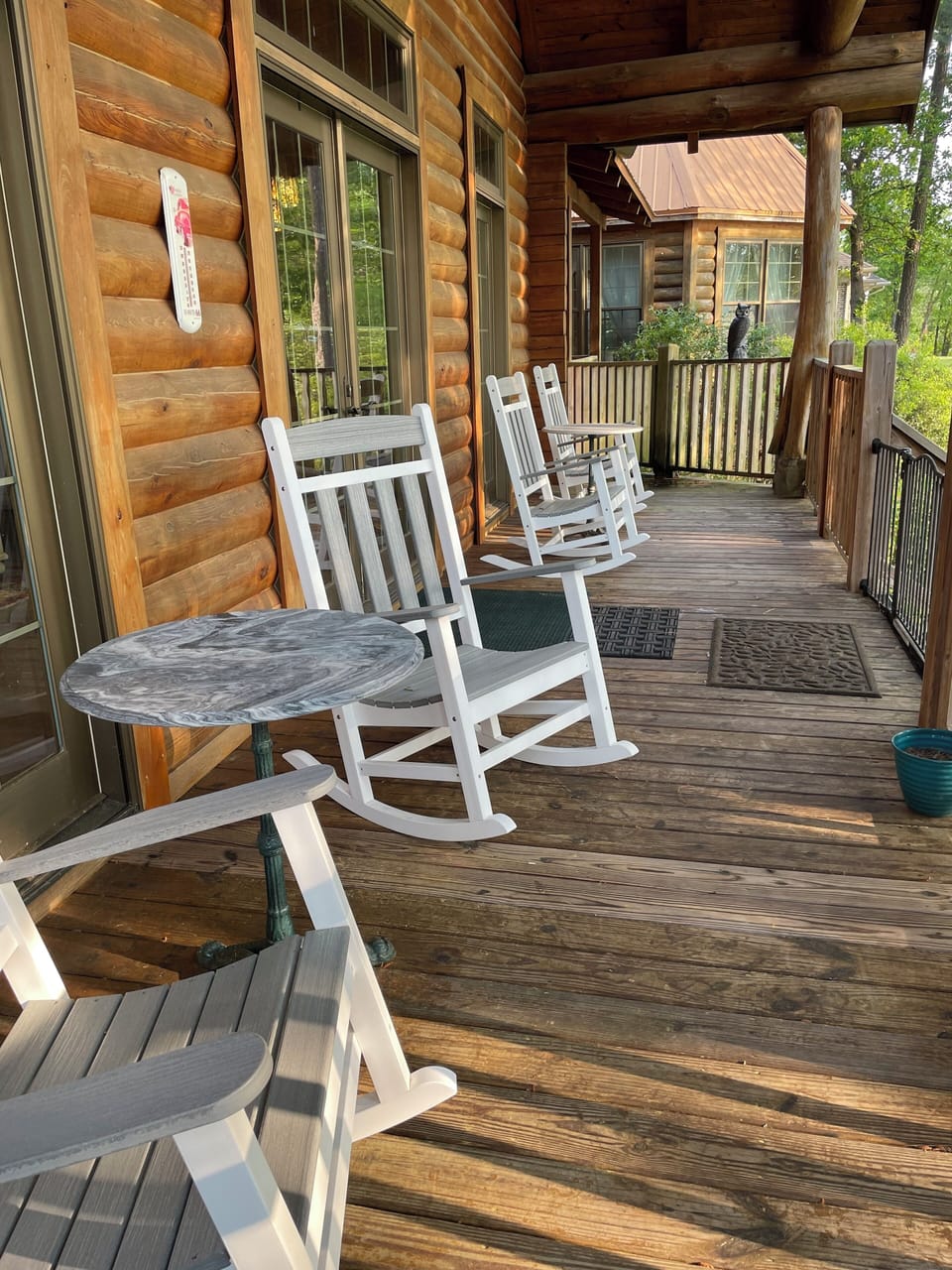 Back Deck overlooks waterfront, has rocking chairs, tables, rope chair swings