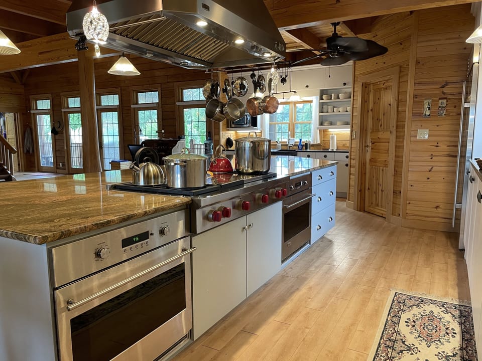 Kitchen with large counter space, gas cooktop, two ovens, microwave and pantry 