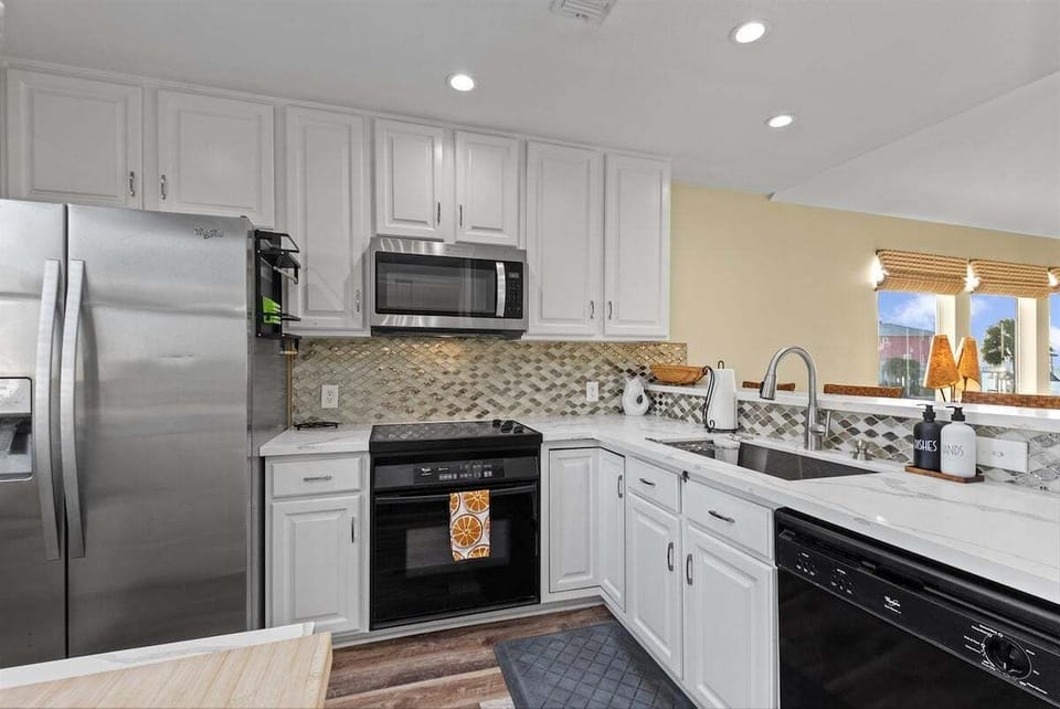 Modern kitchen featuring stainless steel appliances, ample counter space, and everything needed for cooking.