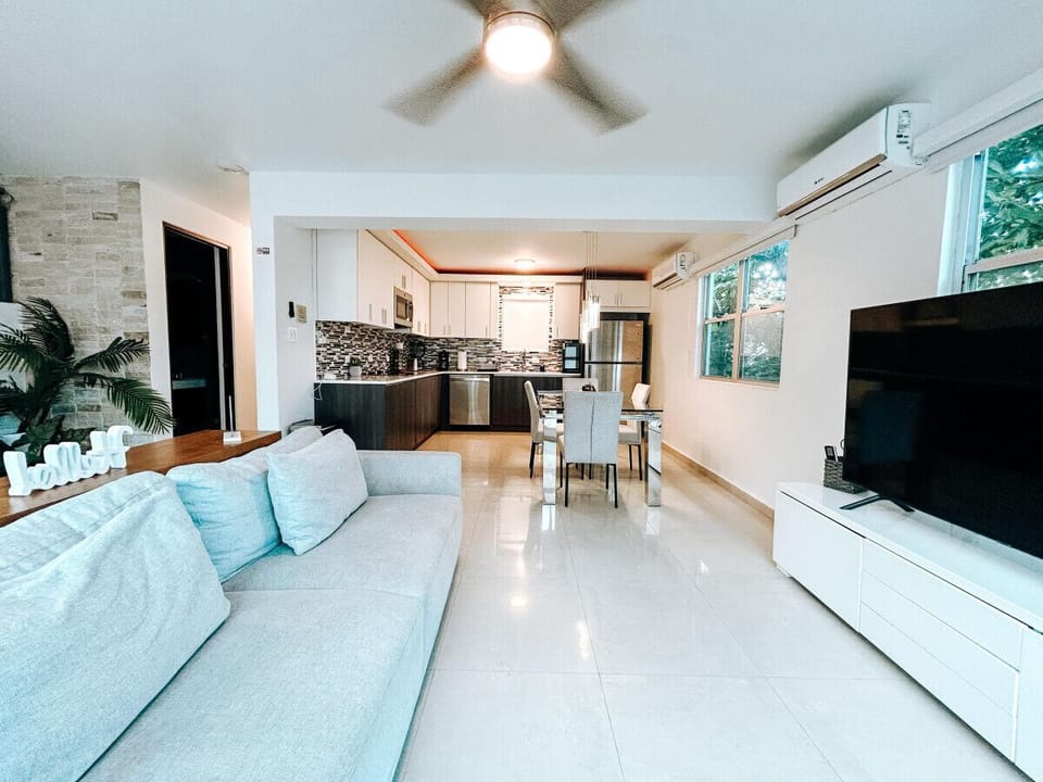 Enjoy a stylish living room with modern decor, soft textures, and plenty of space to sit back and relax with loved ones.