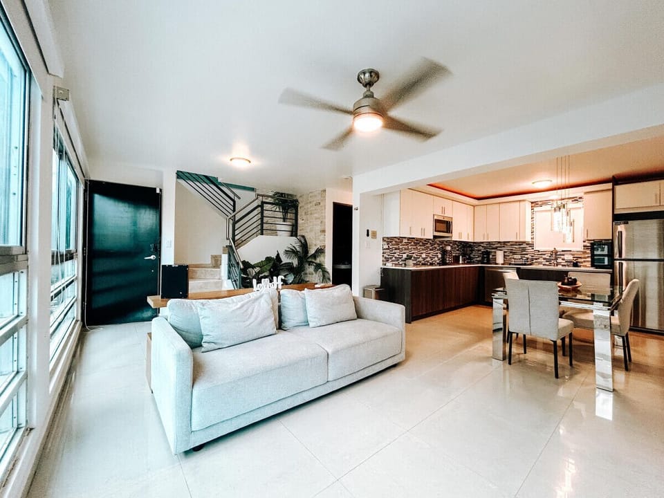 Relax in a warm, inviting living area filled with comfortable seating and thoughtful decor, perfect for gathering and unwinding.