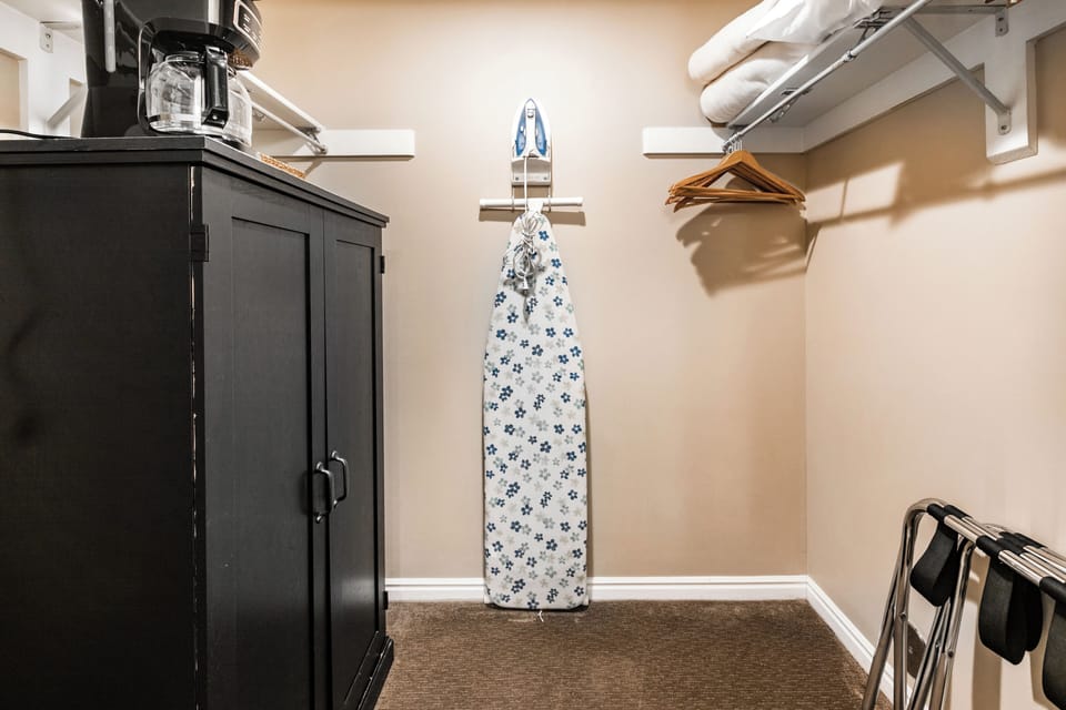 Closet with Iron and Ironing Board, Coffee Maker, and Storage