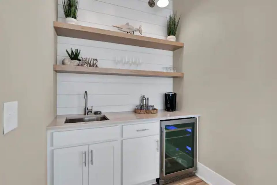 Beverage center w/ wine fridge, Keurig and Cuisinart coffee maker, and glasses