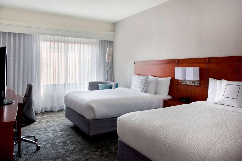 Stretch out in two plush beds beside a bright window.