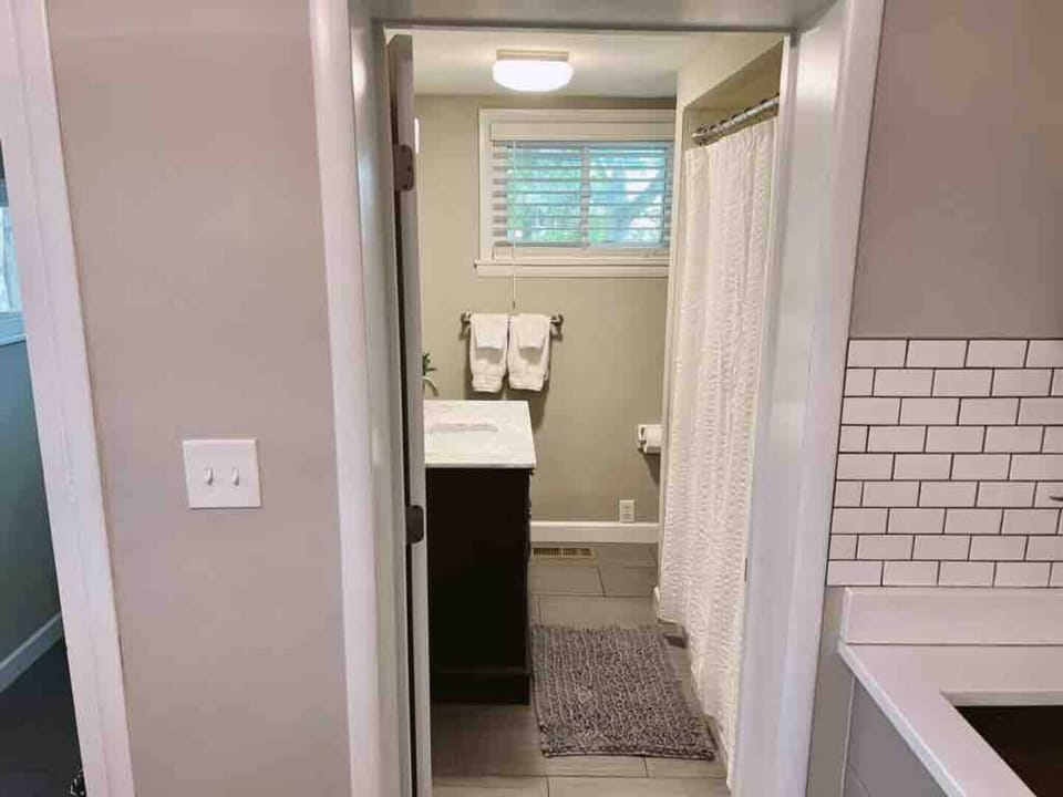 Enter full bathroom on first floor from kitchen.