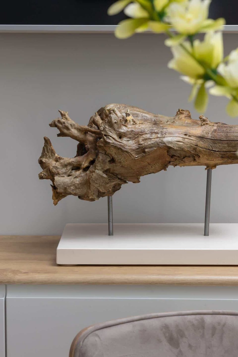 A decorative detail of a small wooden ornament on a shelf, adding character and texture to the interior.

