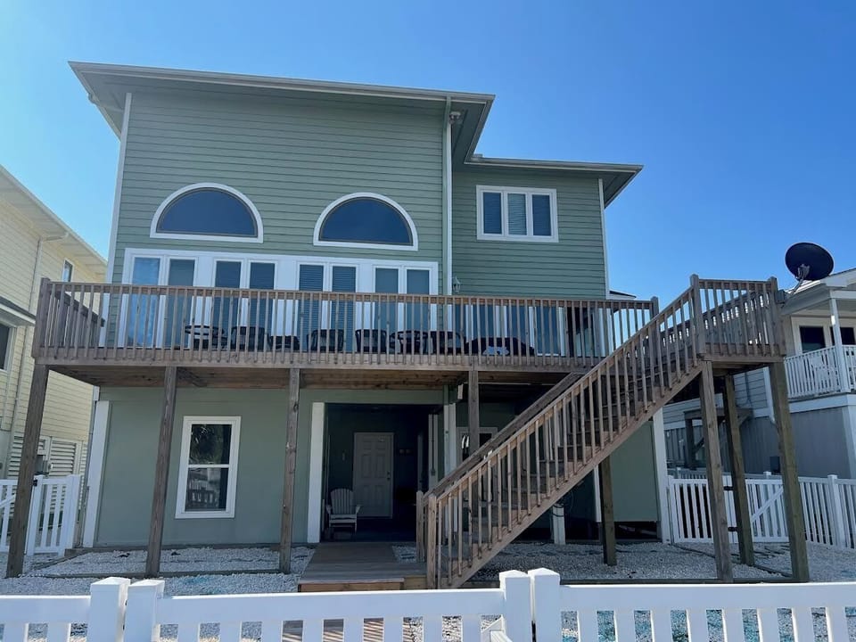 BACK AREA with full canal view deck, new pebble rock, and fenced in for your pet