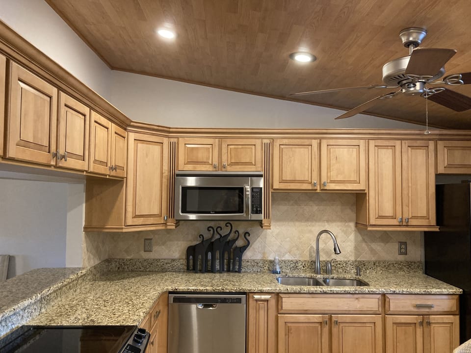 The kitchen also has a stunning cedar wood ceiling with recessed lighting