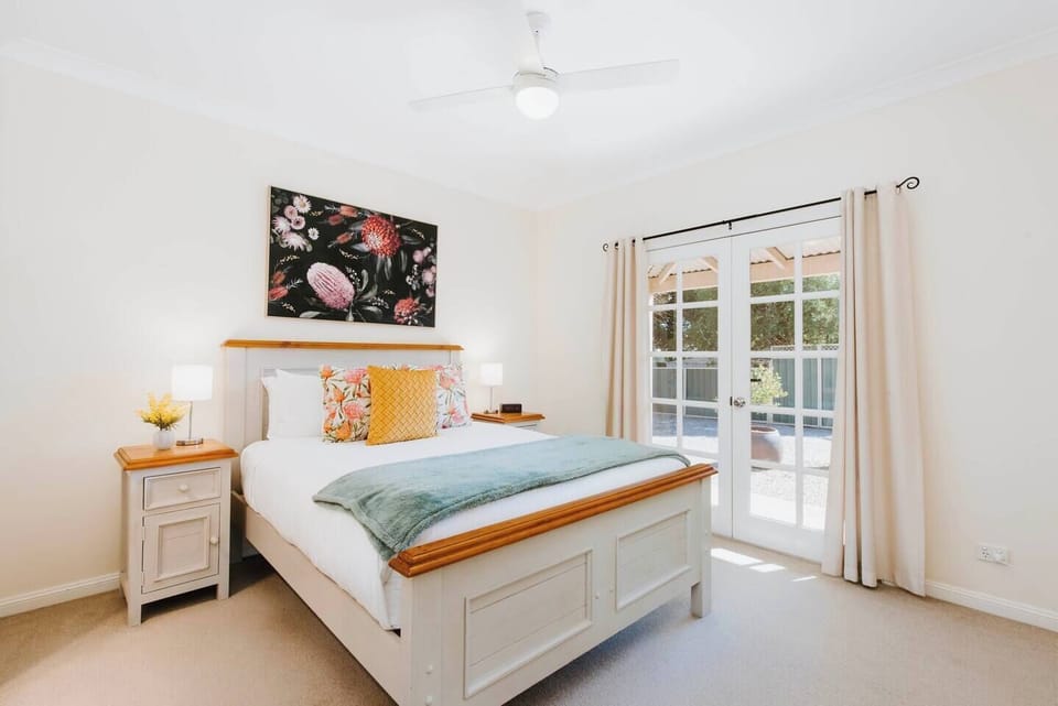 The primary bedroom highlights a queen-sized bed and benefits from a neat ensuite bathroom, wardrobe and own TV.