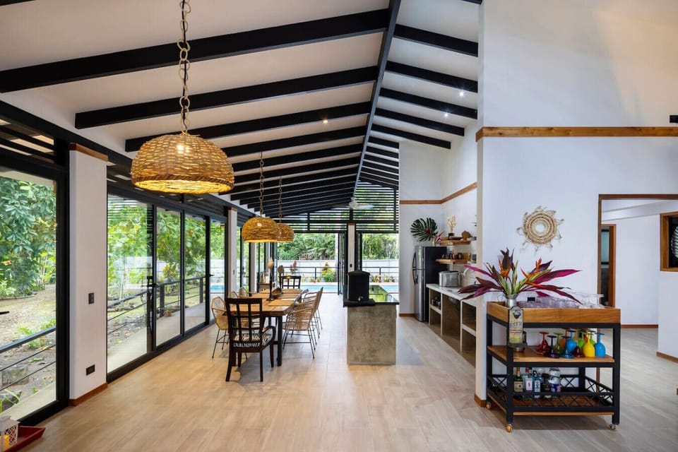 Spacious dining and kitchen area with natural light, garden views, and open-concept design in Puerto Viejo, Casa Kali