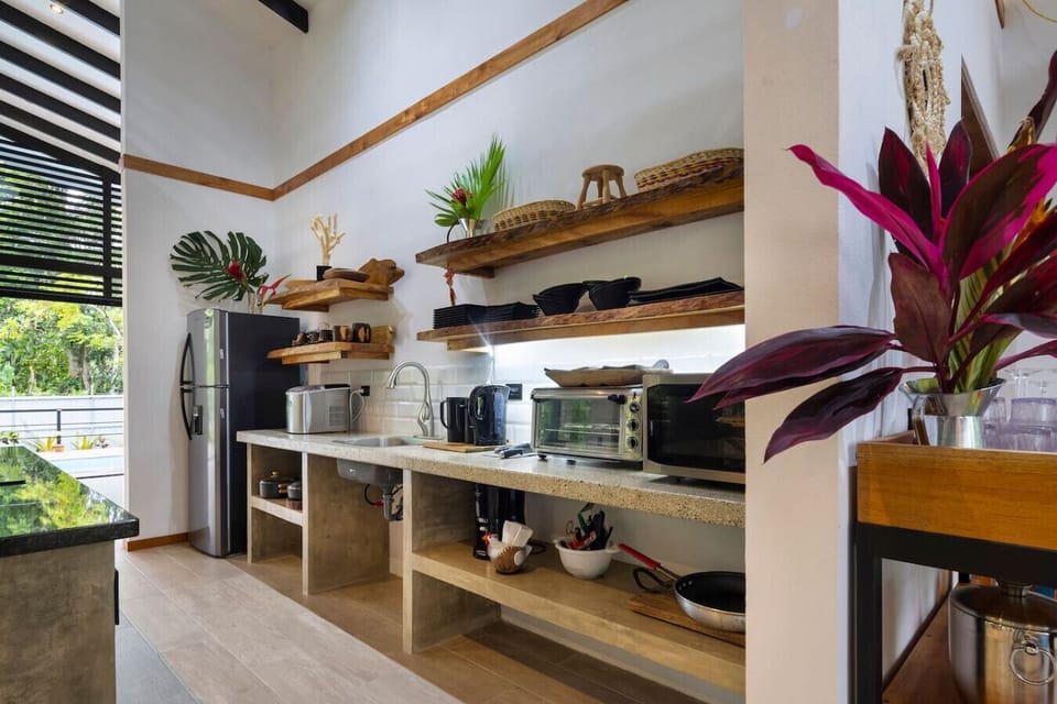 Fully equipped kitchen with open shelving and modern appliances in Puerto Viejo, Casa Kali