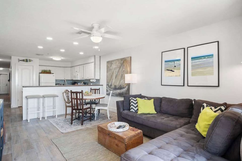 The spacious open floor plan creates a seamless flow between the living, dining, and kitchen areas, perfect for socializing and enjoying time together in a bright and airy space.