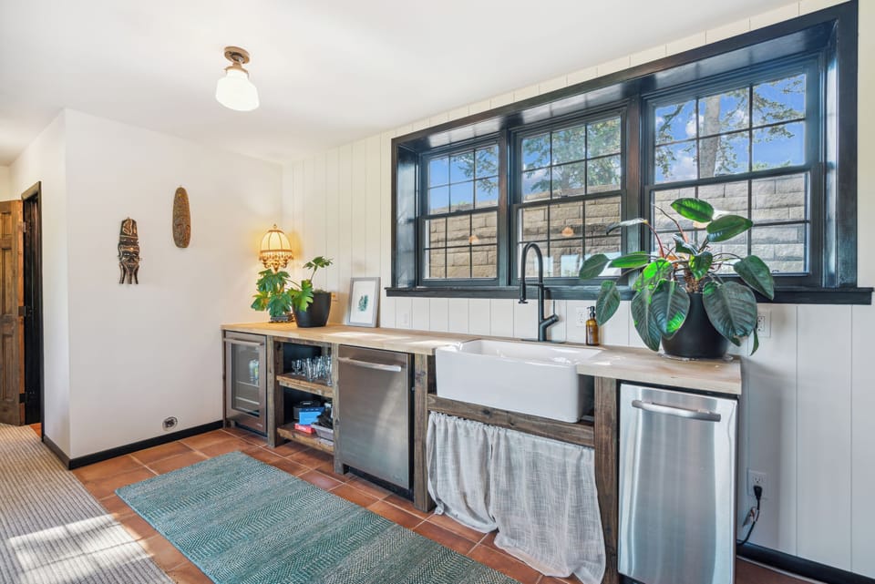 The fully equip wet bar includes a wine fridge, dishwasher, and ice maker. 