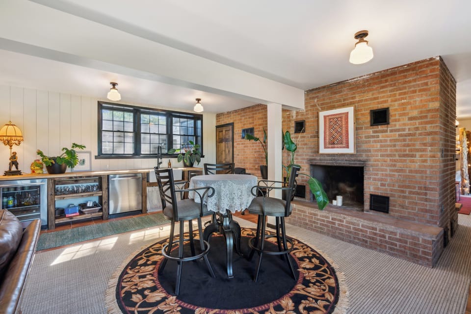 The living room/wet bar hosts a bar table - great for a card game!