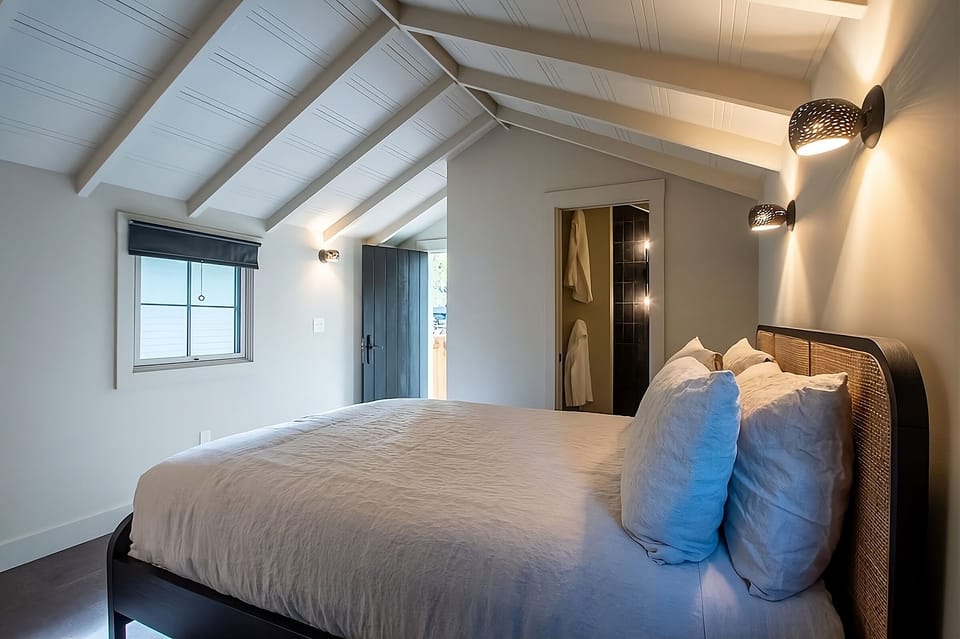 Settle into a serene room with soft lighting and space.