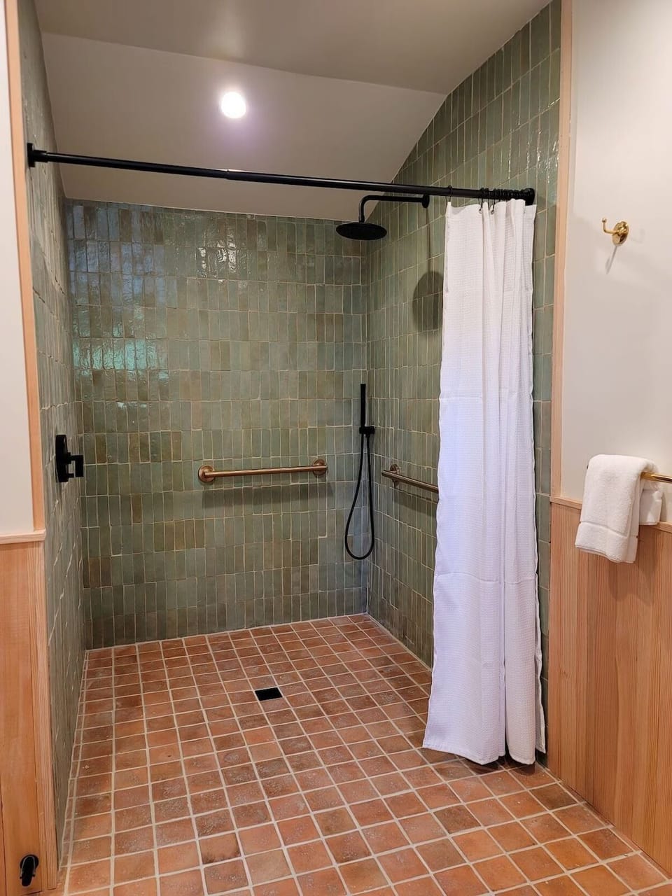 Rinse off comfortably in the roomy walk-in shower space.