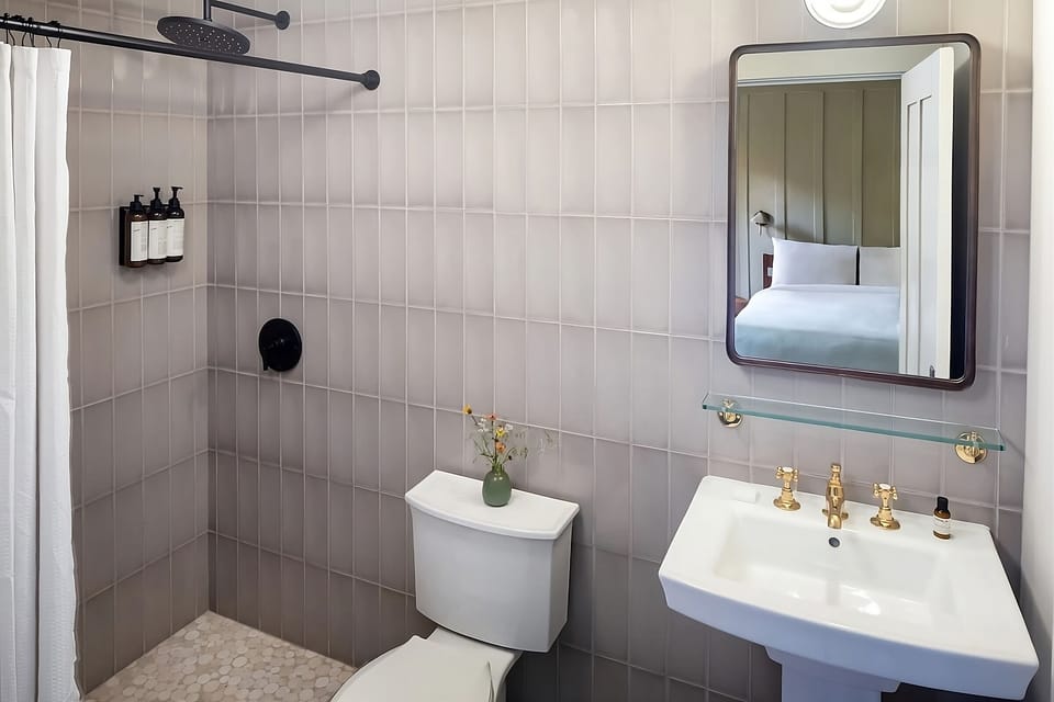 Refresh under a spa-like rain shower with modern tile.