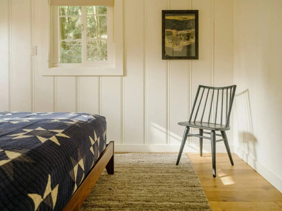 Wake slowly with soft light and a peaceful reading corner.