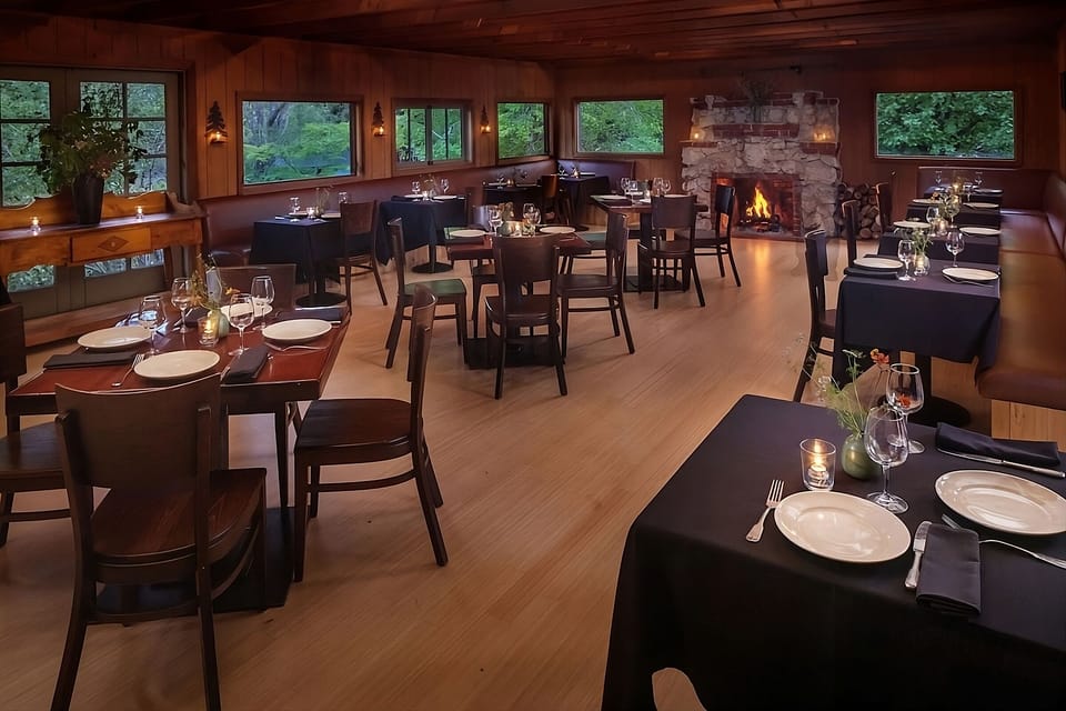 Gather for candlelit dinners in a warm, window-lined room.