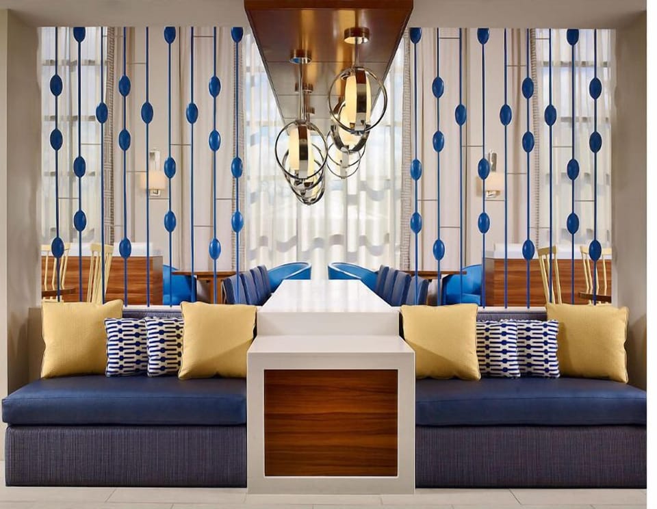 Sink into plush seating beneath warm lights and stylish screens.