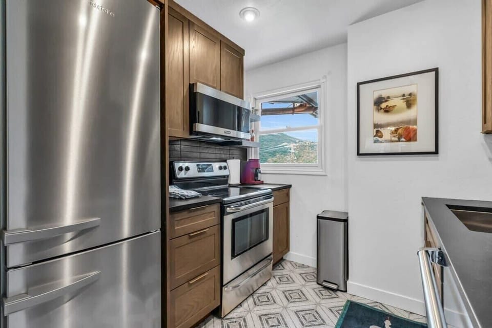 While preparing meals you can enjoy the view out the kitchen window overlooking the city life and the mountains.