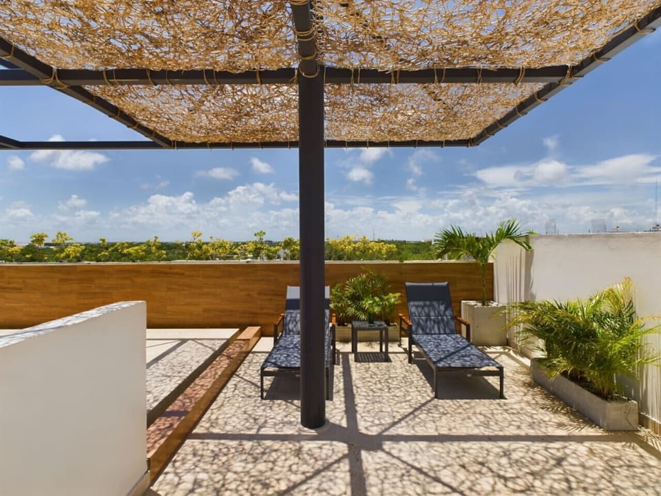 Unwind on your private terrace with sun-ready lounge armchairs.
