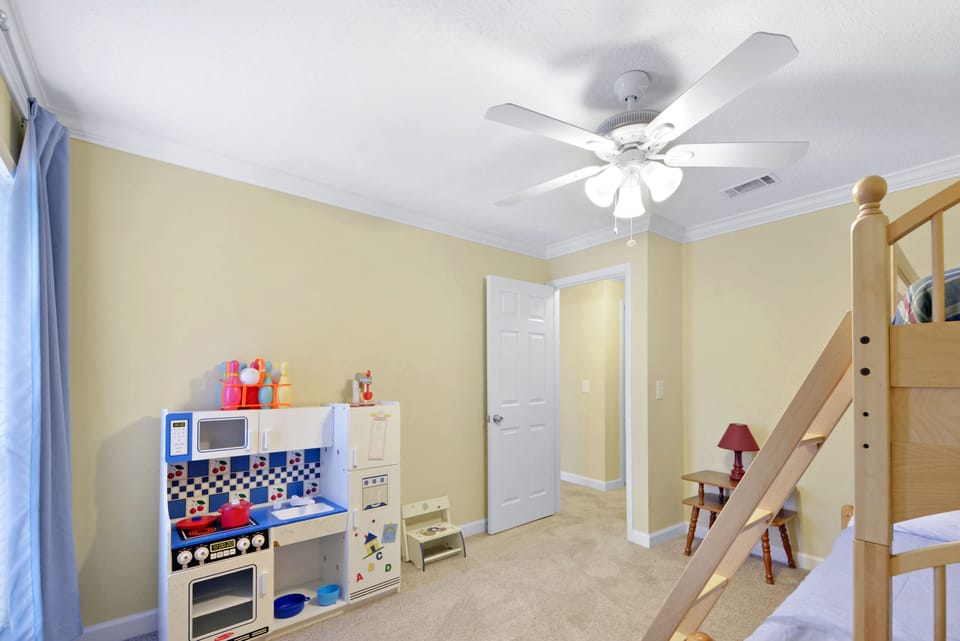 Bunk Room Bonus – Toys, Books & Imagination - This cheerful third bedroom isn’t just for sleep—it’s got a full play kitchen, soft carpet, and space for the littles to dream big between beach days.