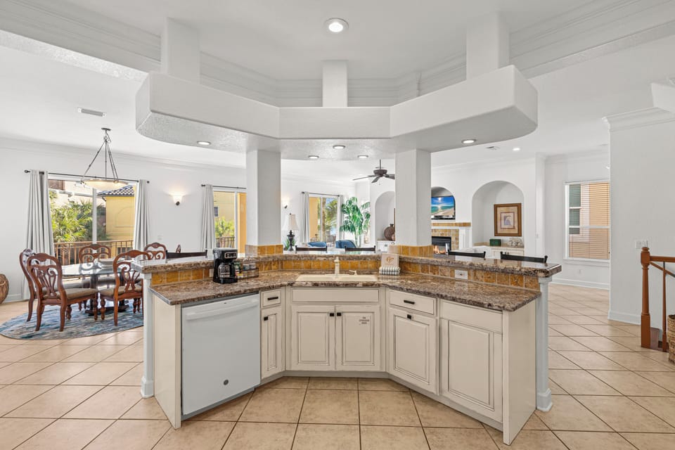 Your spacious kitchen flows beautifully into the dining area, featuring granite counters and elegant white cabinetry perfect for preparing meals.