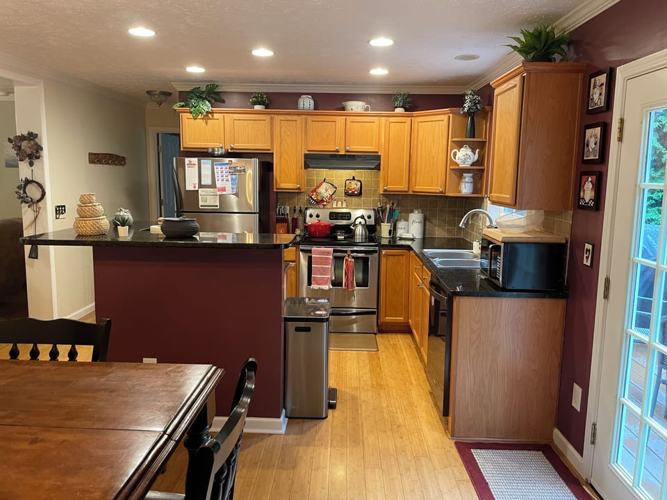 Fully stocked kitchen - pots, pans, plates, measuring cups, cutting board, etc.