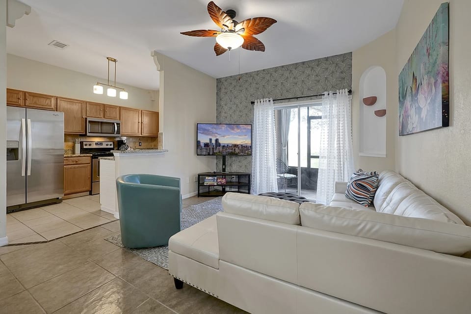 Relax in style. This sun-lit, open-concept lounge features a plush sectional and direct patio access, perfect for family movie nights.