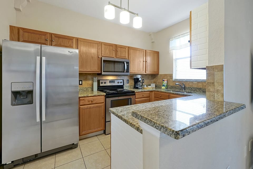 Cook, snack, and gather with ease in this spacious kitchen with stainless steel appliances