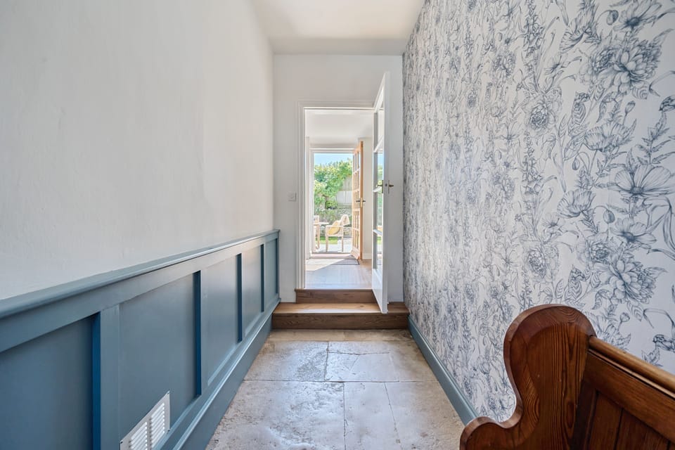 The Old Court House, Cerne Abbas: The main hallway, with it's pretty wallpaper and view through to the garden
