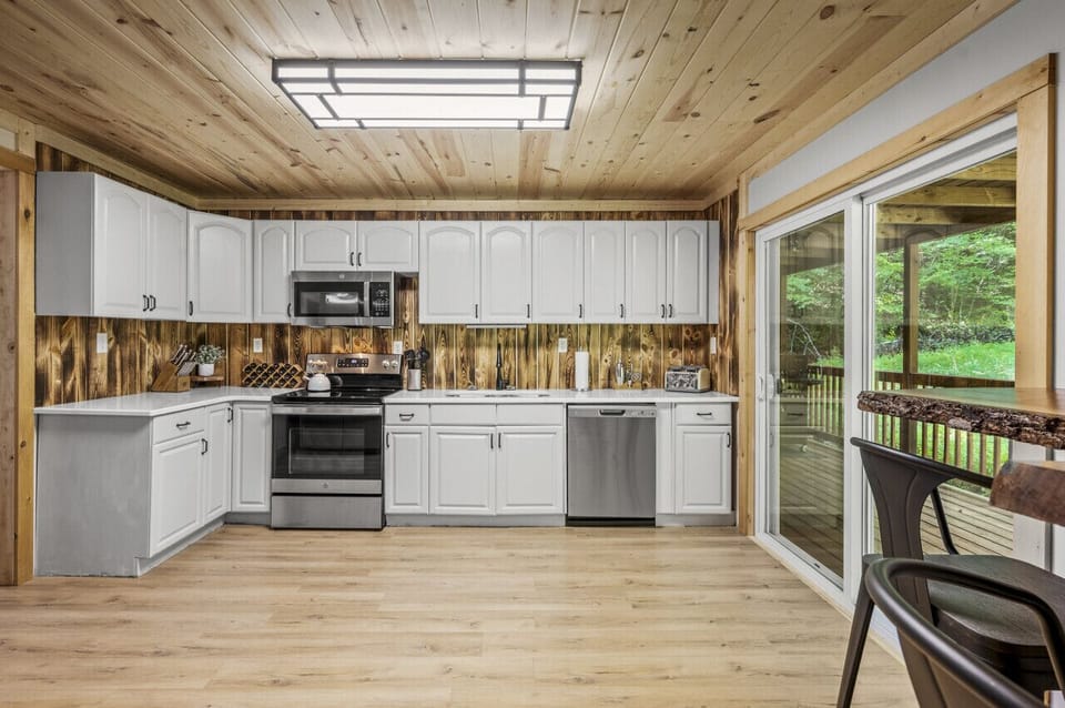 The designer kitchen has sliding glass doors that open out to the deck.