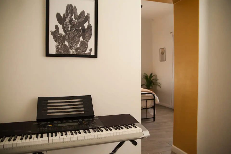 Flex space with yoga mats & keyboard—ideal for music, writing, or quiet time.