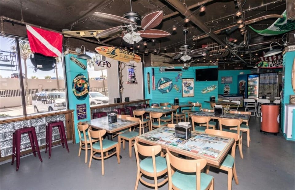 Step into this vibrant dive-themed restaurant where underwater adventure meets delicious dining. The colorful marine décor surrounds your table.
