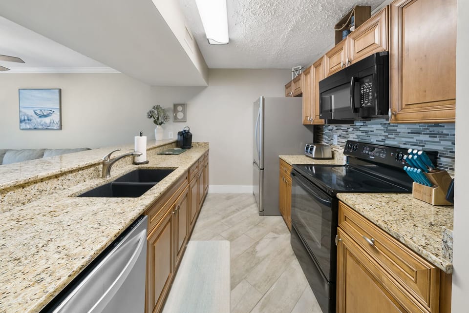 Your spacious kitchen features granite countertops, stainless steel appliances, and everything you need to prepare delicious meals during your stay.