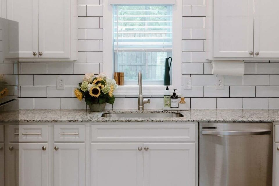 Modern kitchen featuring stainless steel appliances, granite countertops, and all the essentials needed for cooking meals during your Wilmington stay.