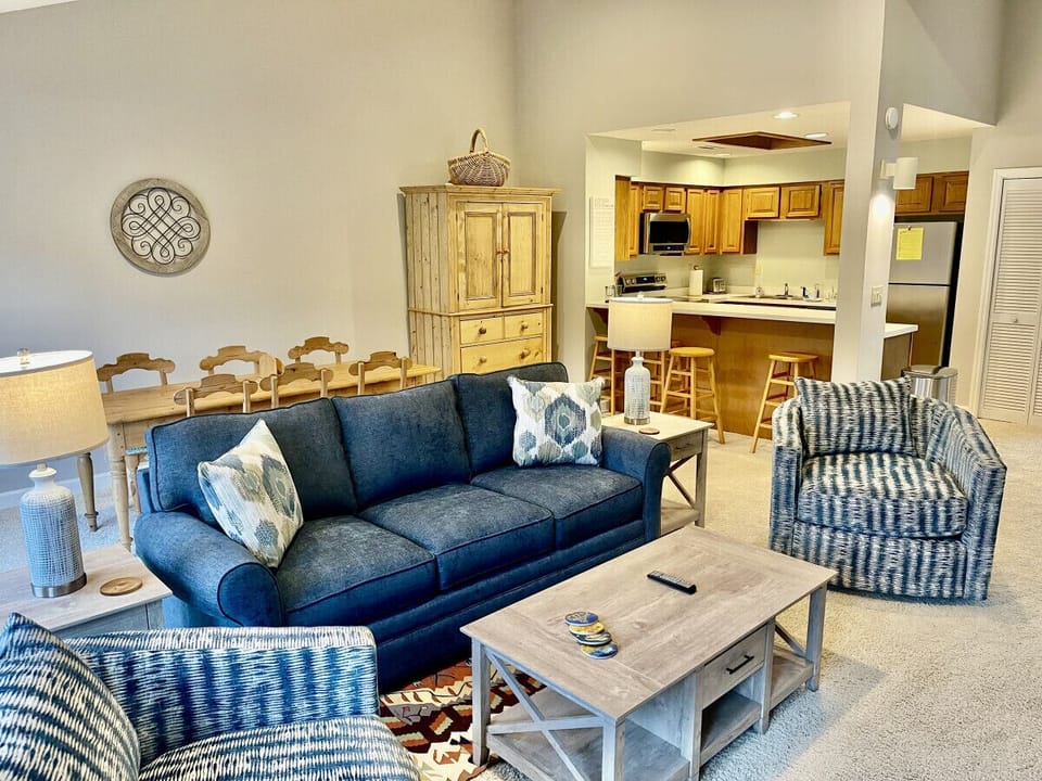 Family room seating area. Brand new furniture including couch and two swivel barrel chairs. 55” smart TV over the fireplace.  Doors open up to upper level balcony with breathtaking views of Lake Lure and the surrounding mountains.