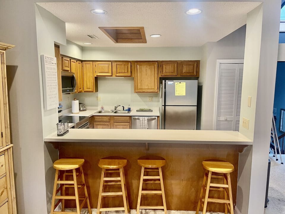 View of the open floor plan kitchen. Kitchen countertop stools seat 4 and makes for a great gathering place to socialize while preparing meals.