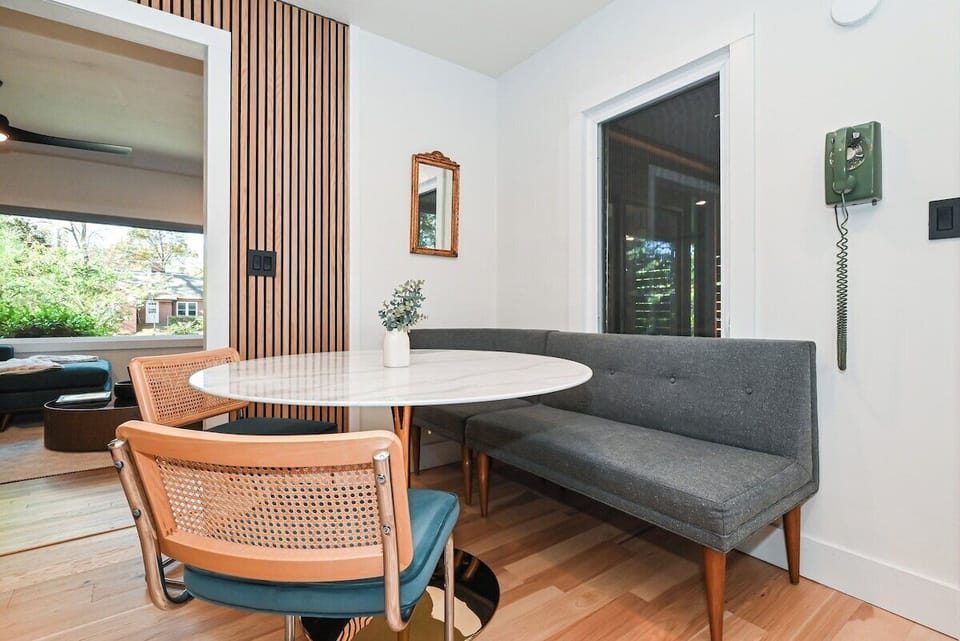 Cozy up in this built-in banquette dining area with soft seating and natural light—perfect for breakfast, games, or wine nights.